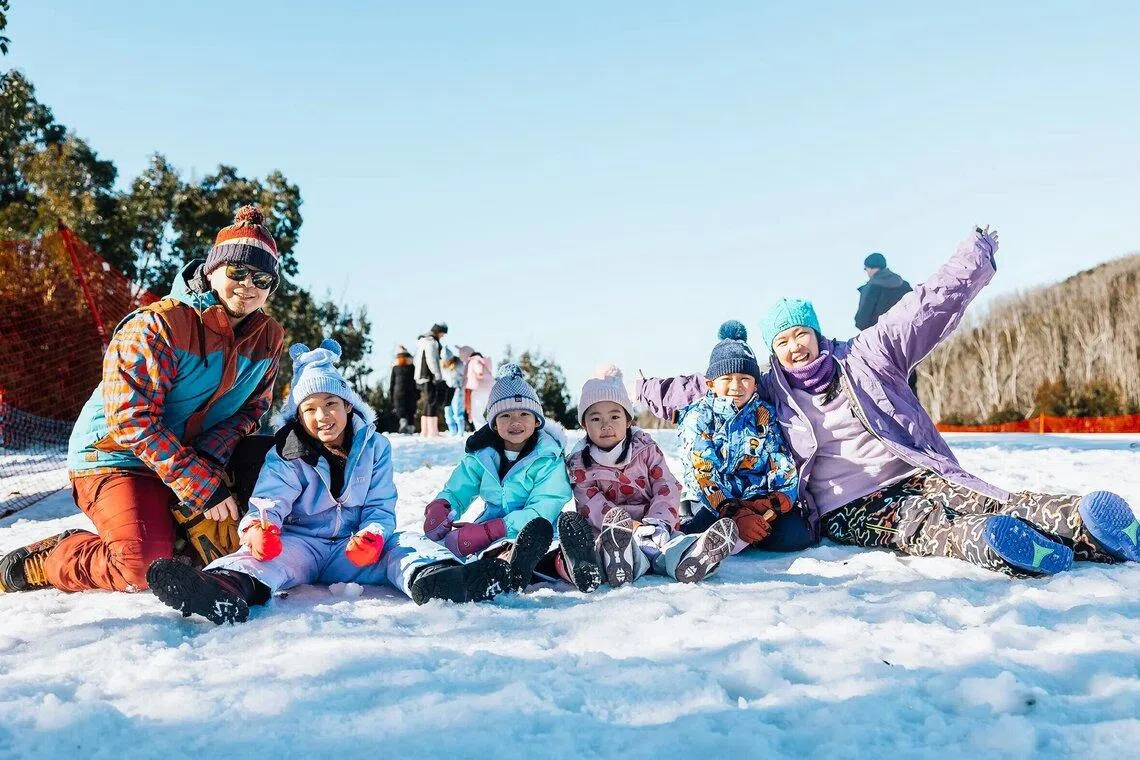 Asian family have snow fun at Lake Mountain Alpine Resort