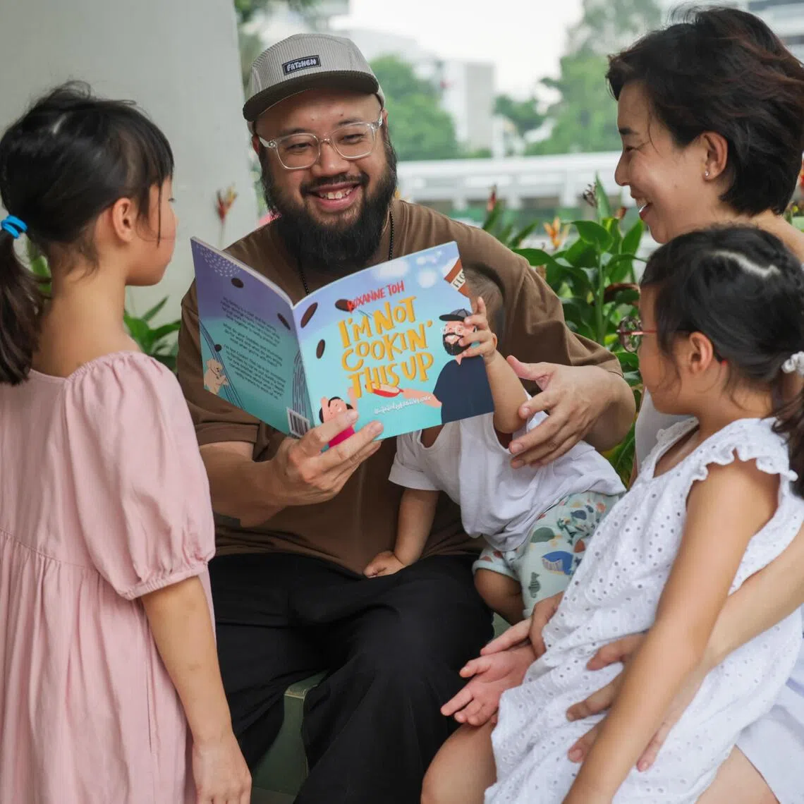 Chef Bjorn Shen reads I’m Not Cookin’ This Up to his three kids. The picture book is written by his wife Roxanne Toh.