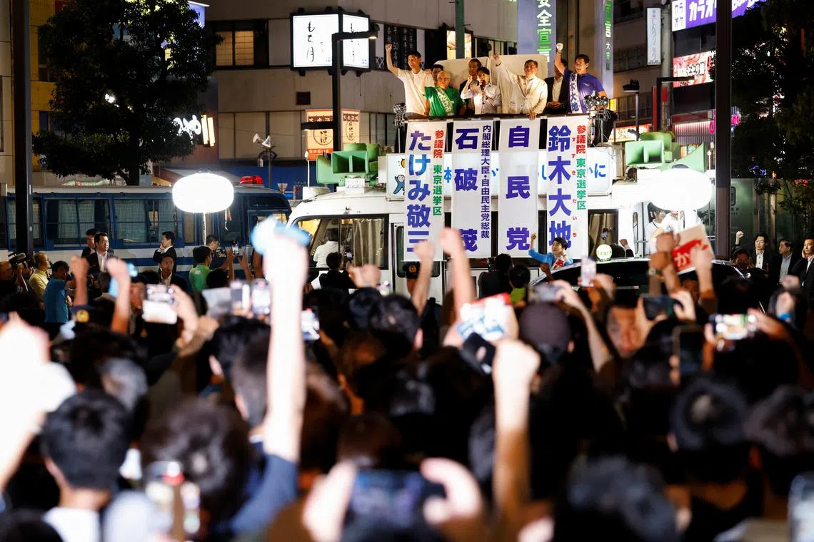 Japan's Prime Minister Shigeru Ishiba, leader of the Liberal Democratic Party (LDP), raises his fist from atop the campaigning bus on the last day of campaigning for the July 20 upper house election, in Tokyo, Japan July 19, 2025. REUTERS/Manami Yamada