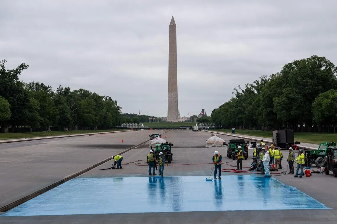Crews spray a new blue coating on the Lincoln Memorial Reflecting Pool on April 25 in Washington, DC. US President Donald Trump rejected a proposal to replace the stone in the bottom.