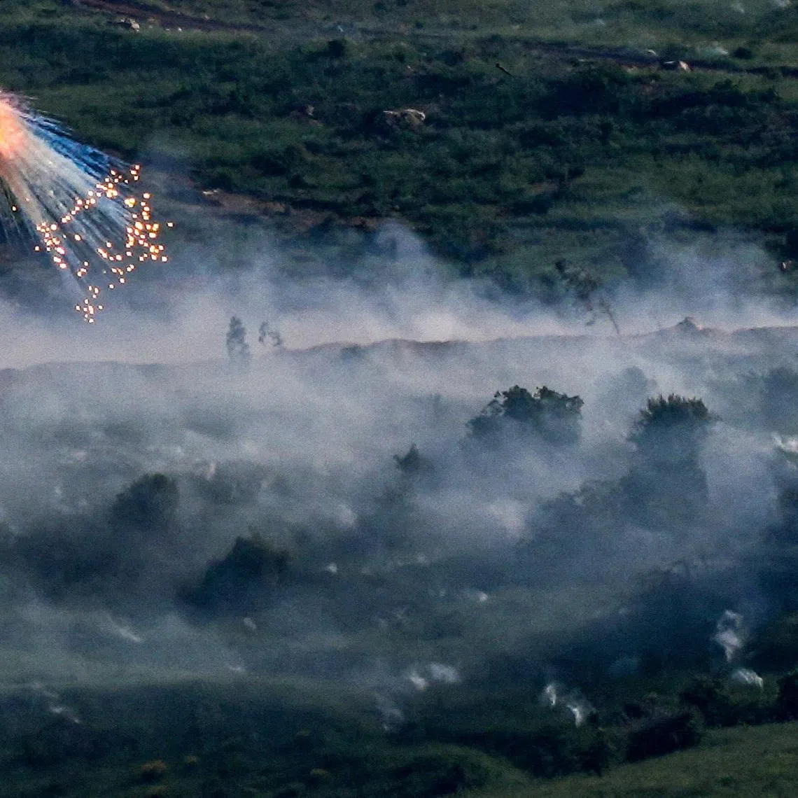 FILE PHOTO: An explosion of what appears to be white phosphorus fired by the Israeli military on the Lebanese side of the Israel-Lebanon border as seen from the Israeli side of the border, May 10, 2026. REUTERS/Ayal Margolin/File Photo
