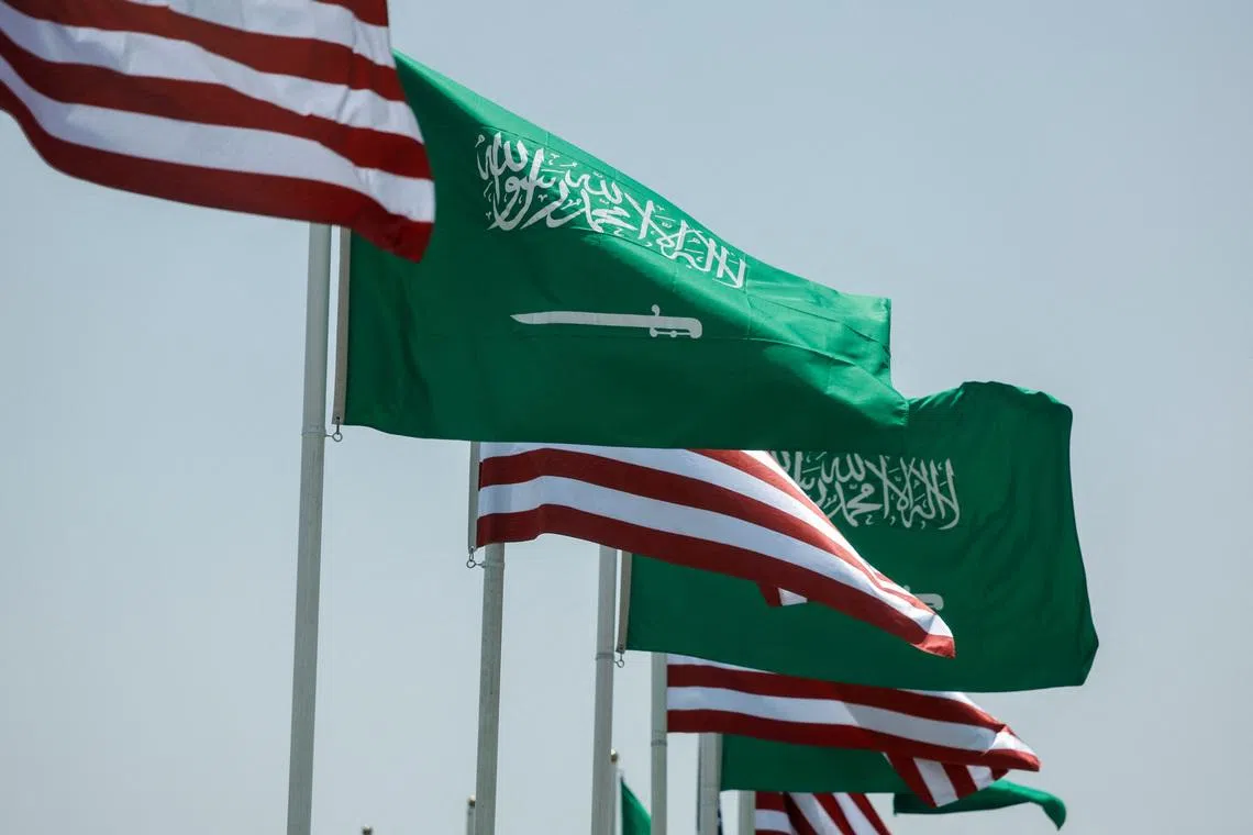 FILE PHOTO: U.S. and Saudi flags flutter along a highway of Riyadh, as pictured through the glass of a car, ahead of the arrival of U.S. President Donald Trump to Riyadh, Saudi Arabia May 12, 2025. REUTERS/Hamad I Mohammed/ File Photo