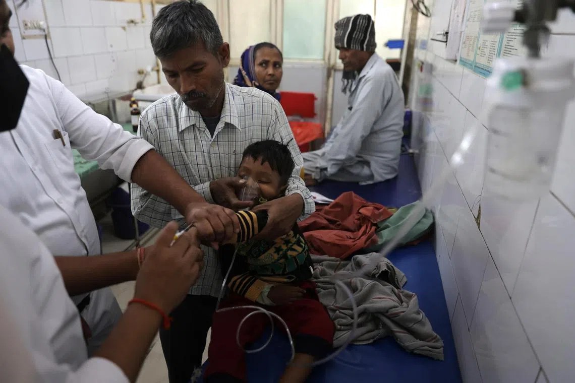 A child receives oxygen at a hospital in Uttar Pradesh that has been treating 50 patients daily with breathing problems.