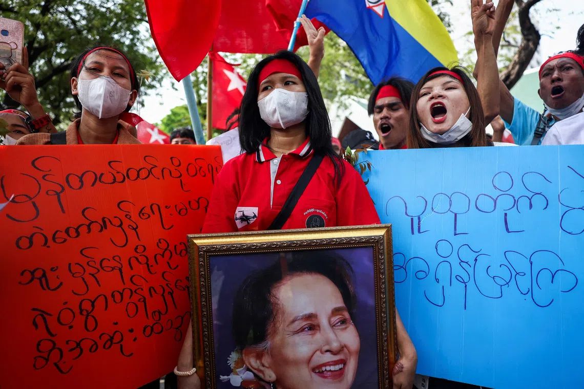 Protesters hold up a portrait of Aung San Suu Kyi during a demonstration outside of the United Nations office in Bangkok, Thailand, on Feb 1, 2024.
