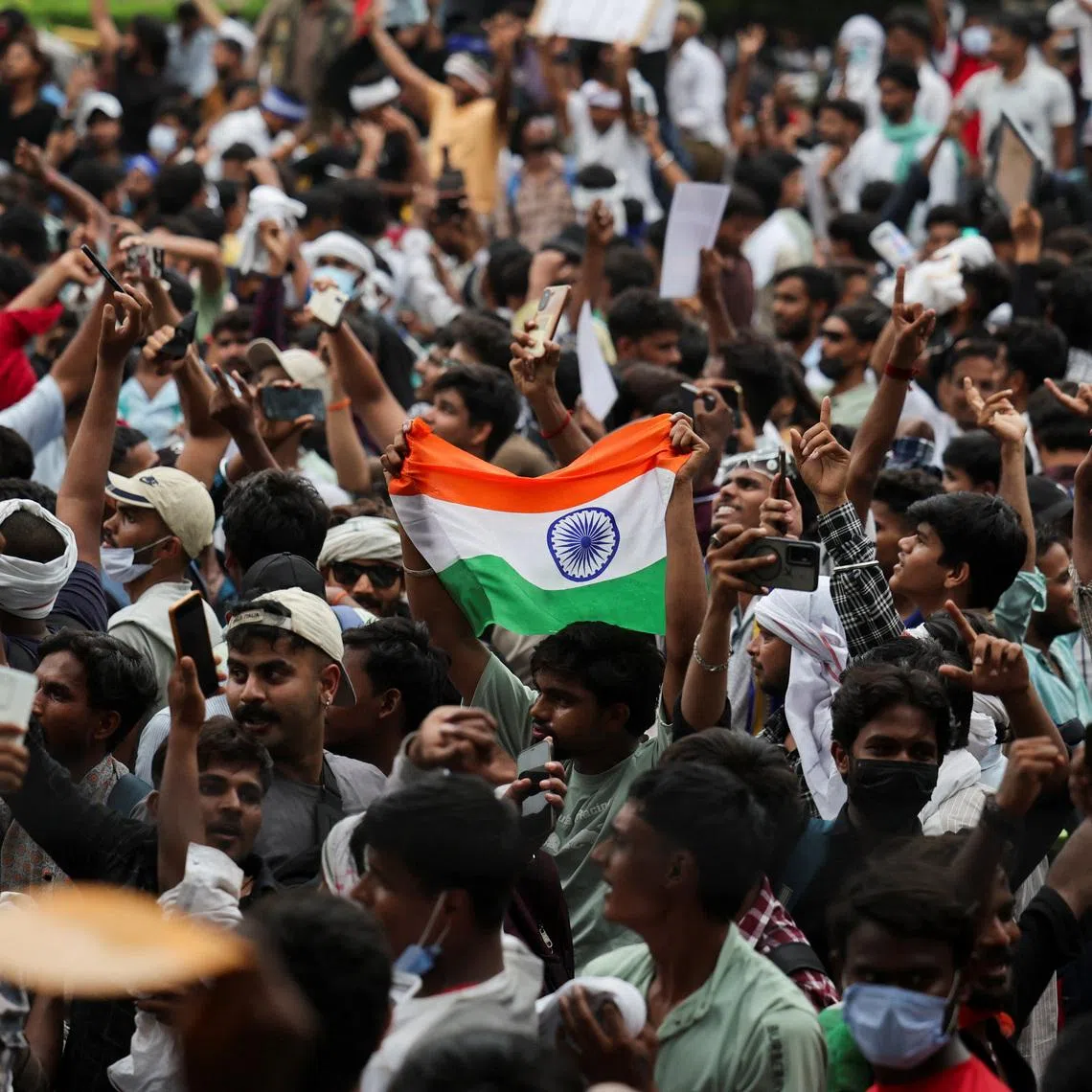 Supporters of India’s Cockroach Janta Party celebrate on July 25 after India’s Education Minister Dharmendra Pradhan resigned.