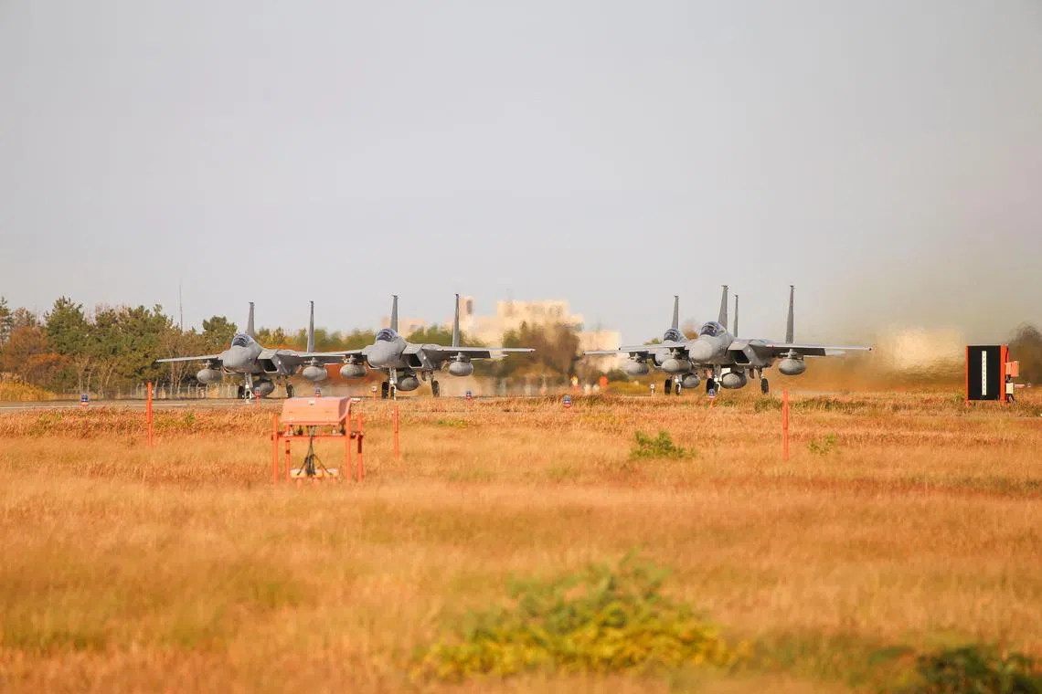 This handout photo taken and released by Japan's Ministry of Defence on Nov 18, 2022, shows military jets preparing to take off as Japan's Self-Defence Forces and US Armed Forces conduct a bilateral exercise over the Sea of Japan, also known as the East Sea, at an undisclosed location in Japan. 