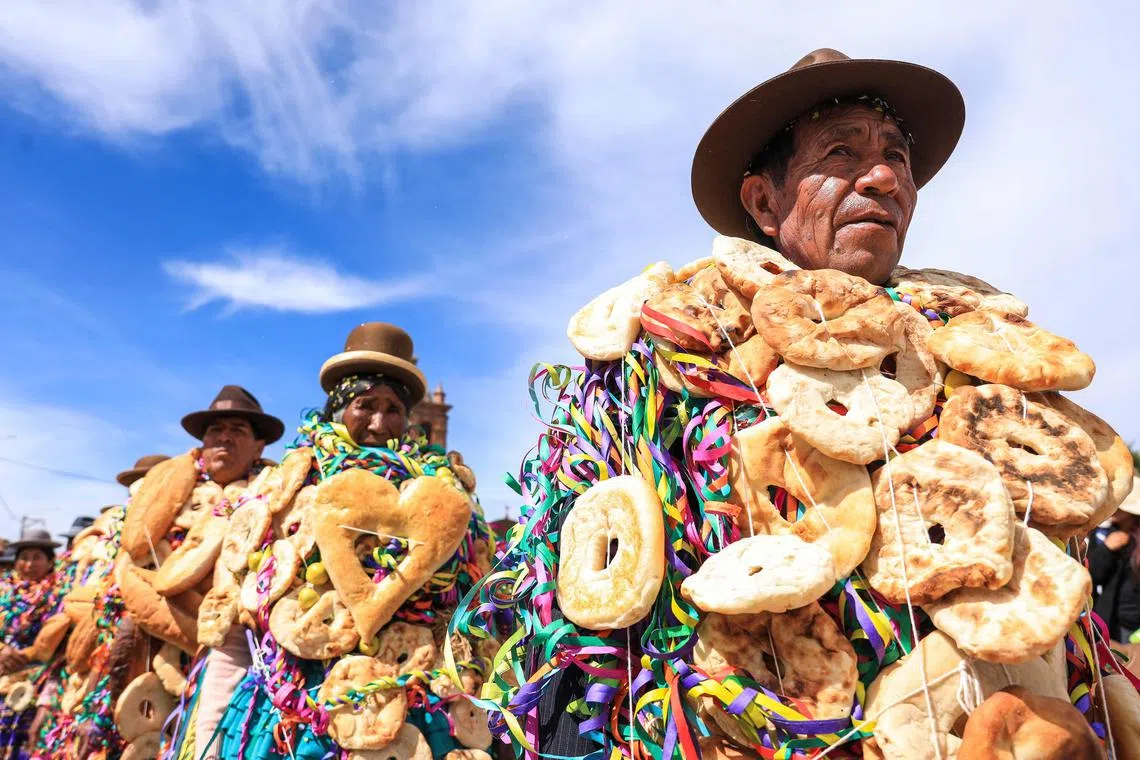 Aymara Indigenous people celebrate the "Roscasiri" in the Pomata District, one of seven districts of the Chucuito Province in the Puno Region, southern Peru, on Jan 1, 2025. This ancient Aymara event, in which people decorate themselves with breads and fruits that represent abundance for the new year.