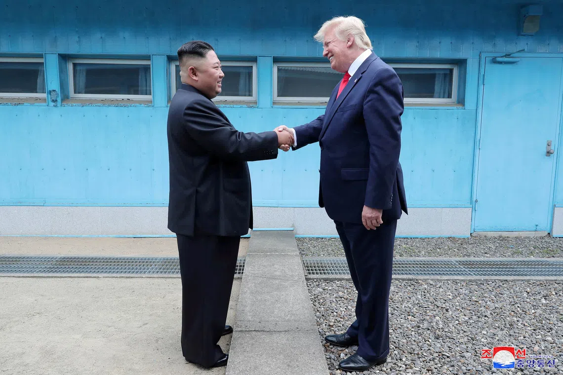 A 2019 photo shows US President Donald Trump (right) shaking hands with North Korean leader Kim Jong Un at the demilitarized zone in South Korea.