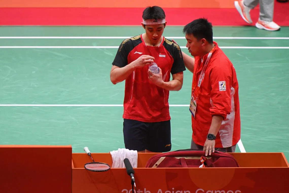 Singapore’s Loh Kean Yew (left) speaking to his coach Kelvin Ho during the Asian Games badminton men’s singles final against Thailand’s Kunlavut Vitidsarn on Sept 28.