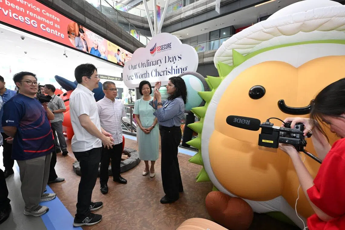Prime Minister Lawrence Wong, Edwin Tong, Second Minister for Home Affairs and Law Minister, and Sim Ann, Senior Minister of State for Foreign Affairs and Home Affairs, touring the SGSecure 10th Anniversary Exhibition at Our Tampines Hub on Sept 23.