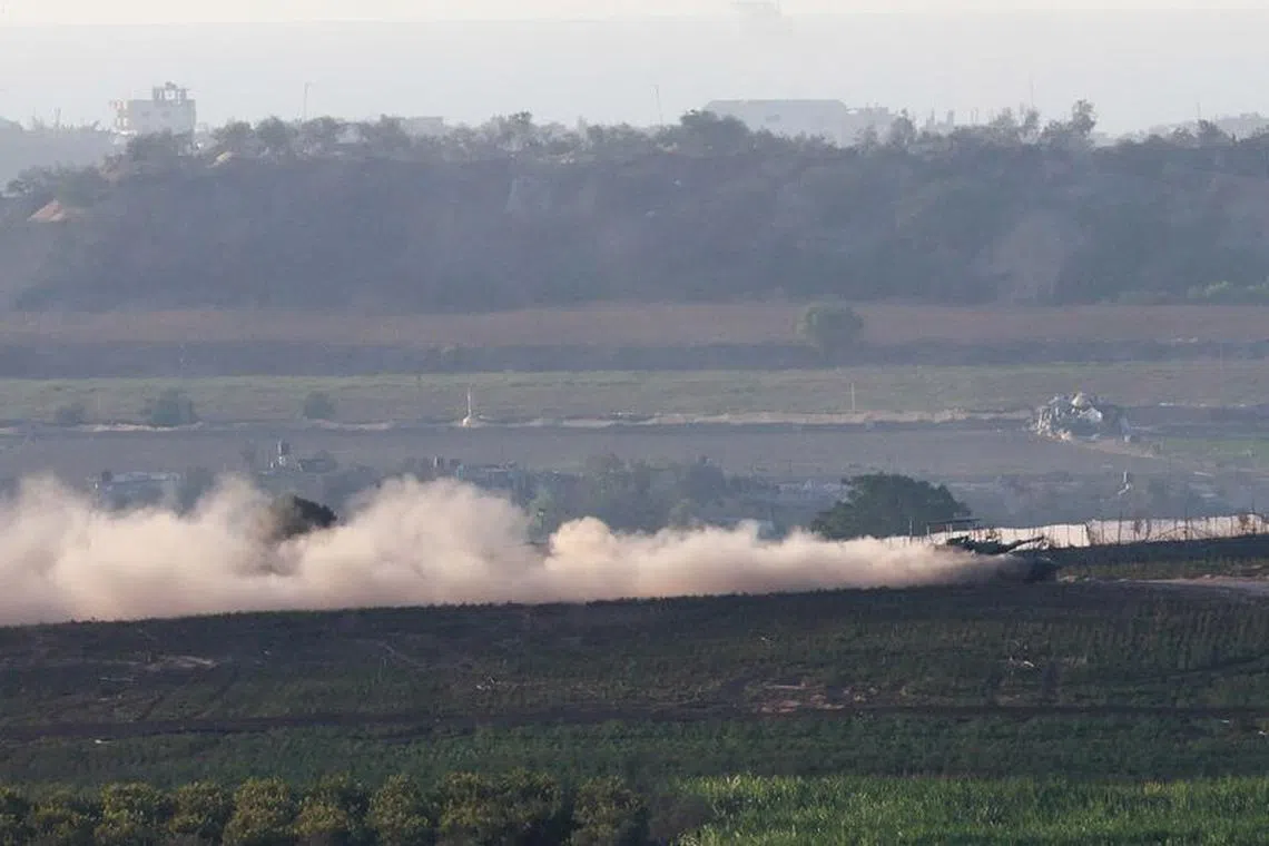A tank manoeuvres at the border between Israel and the Gaza strip, amid the ongoing conflict between Israel and Palestinian Islamist group Hamas, as seen from Sderot in southern Israel, November 7, 2023. REUTERS/Ammar Awad