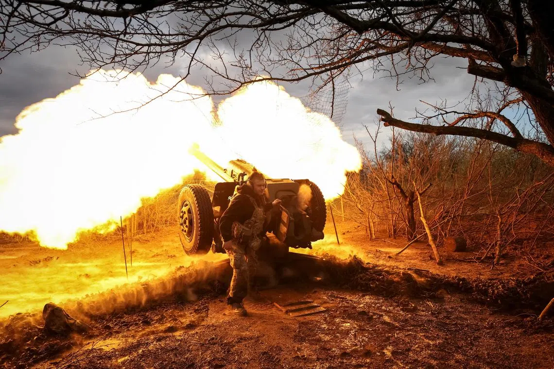 A Ukrainian service member fire a howitzer D30 at a front line, near the city of Bakhmut, on April 23.