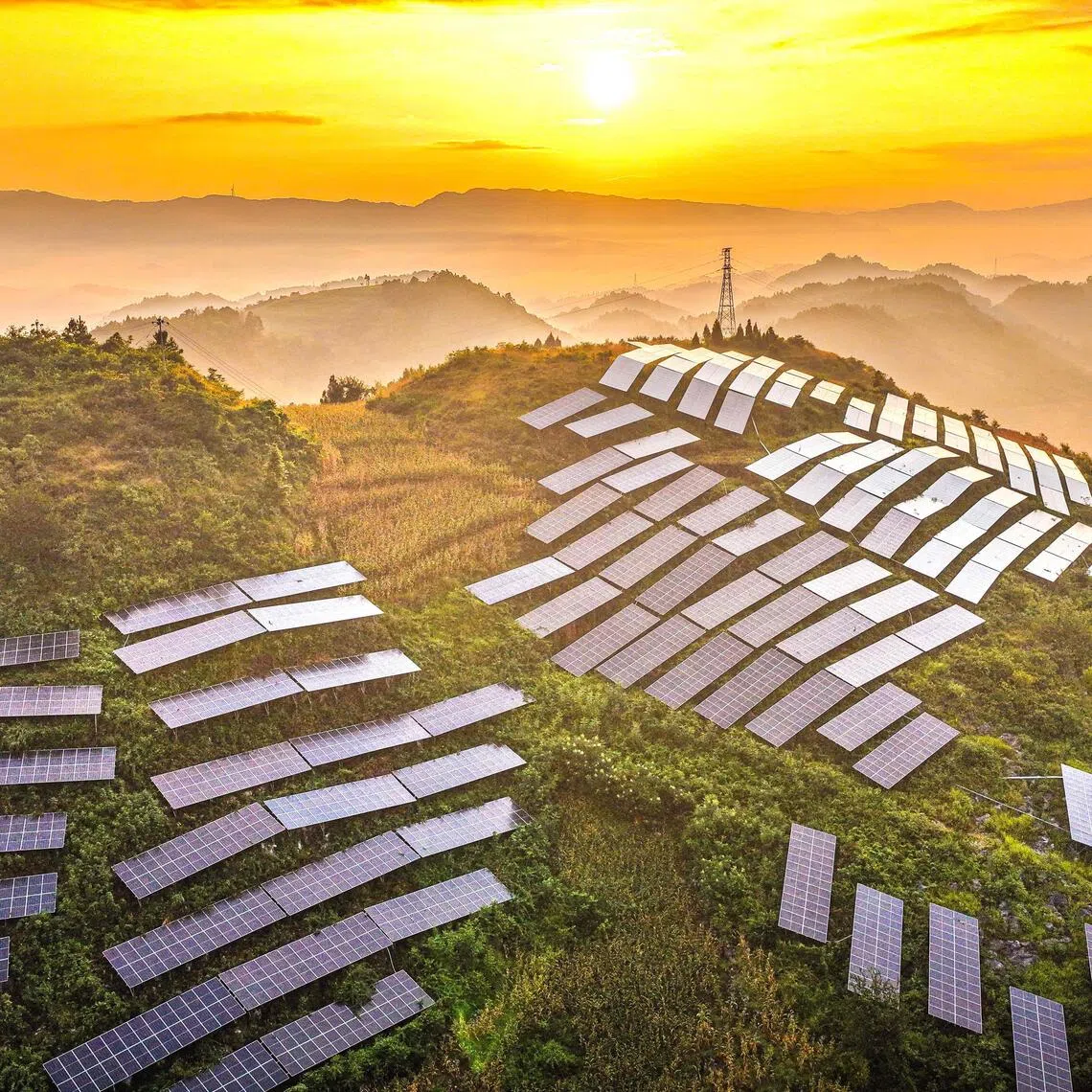 TOPSHOT - Solar panels are arranged on a hillside at an agricultural photovoltaic power station in Dingxin Yi and Miao Ethnic Township, Qianxi City, in southwestern China's Guizhou province, on August 17, 2026. (Photo by CN-STR / AFP) / China OUT