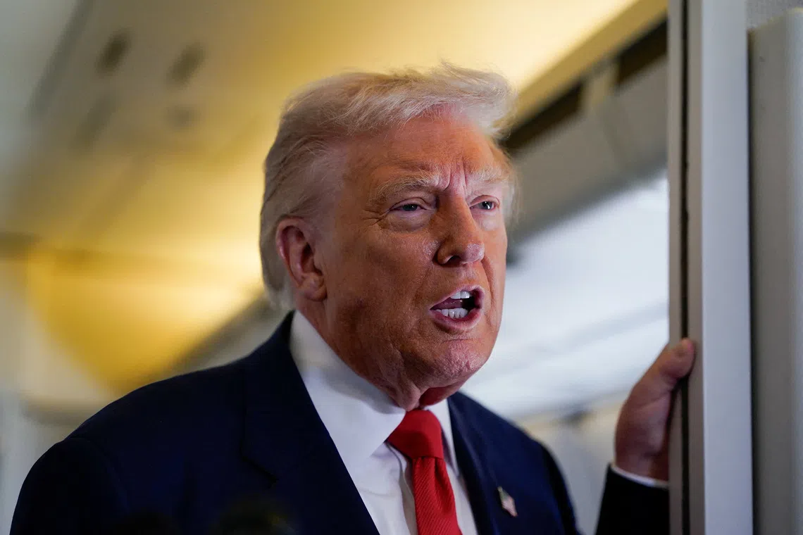 U.S. President Donald Trump speaks to members of the media aboard Air Force One as he departs for Florida from Joint Base Andrews, Maryland, U.S., October 31, 2025. REUTERS/Elizabeth Frantz