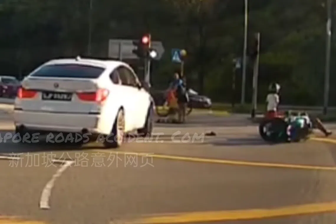 A white car was making a right turn when the motorcycle self skidded. 