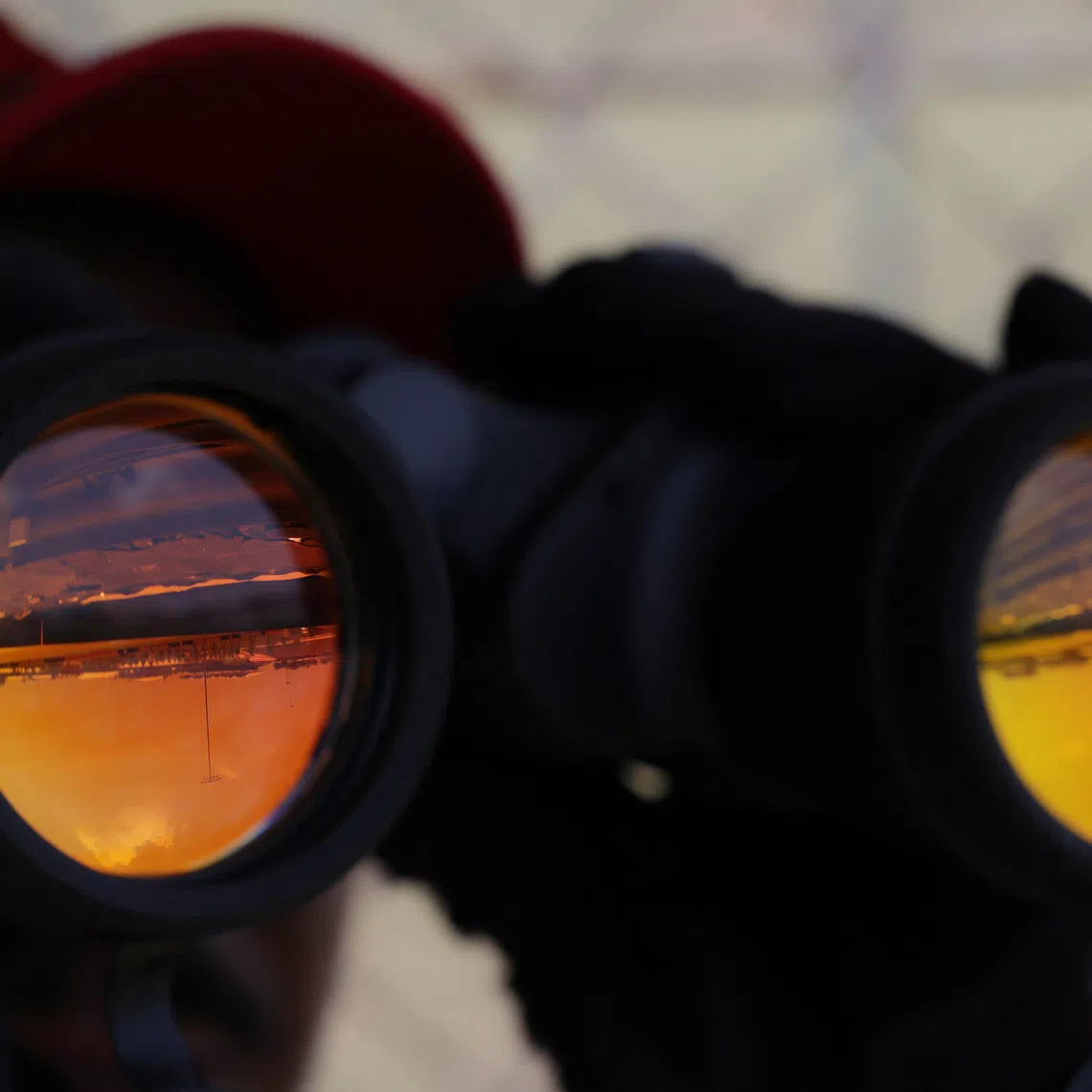 Formula One F1 - Bahrain Grand Prix - Sepang International Circuit, Sepang, Malaysia - October 2, 2026 A fan watches on with binoculars during practice 1 REUTERS/Annice Lyn