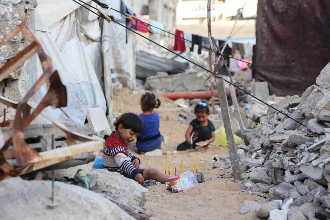TOPSHOT - Palestinian children play amid the rubble of destroyed buildings in Gaza City, in the central Gaza Strip on April 26, 2025. Israel resumed its military campaign in the Gaza Strip on March 18, ending a two-month truce that had largely halted the fighting. (Photo by Omar AL-QATTAA / AFP)