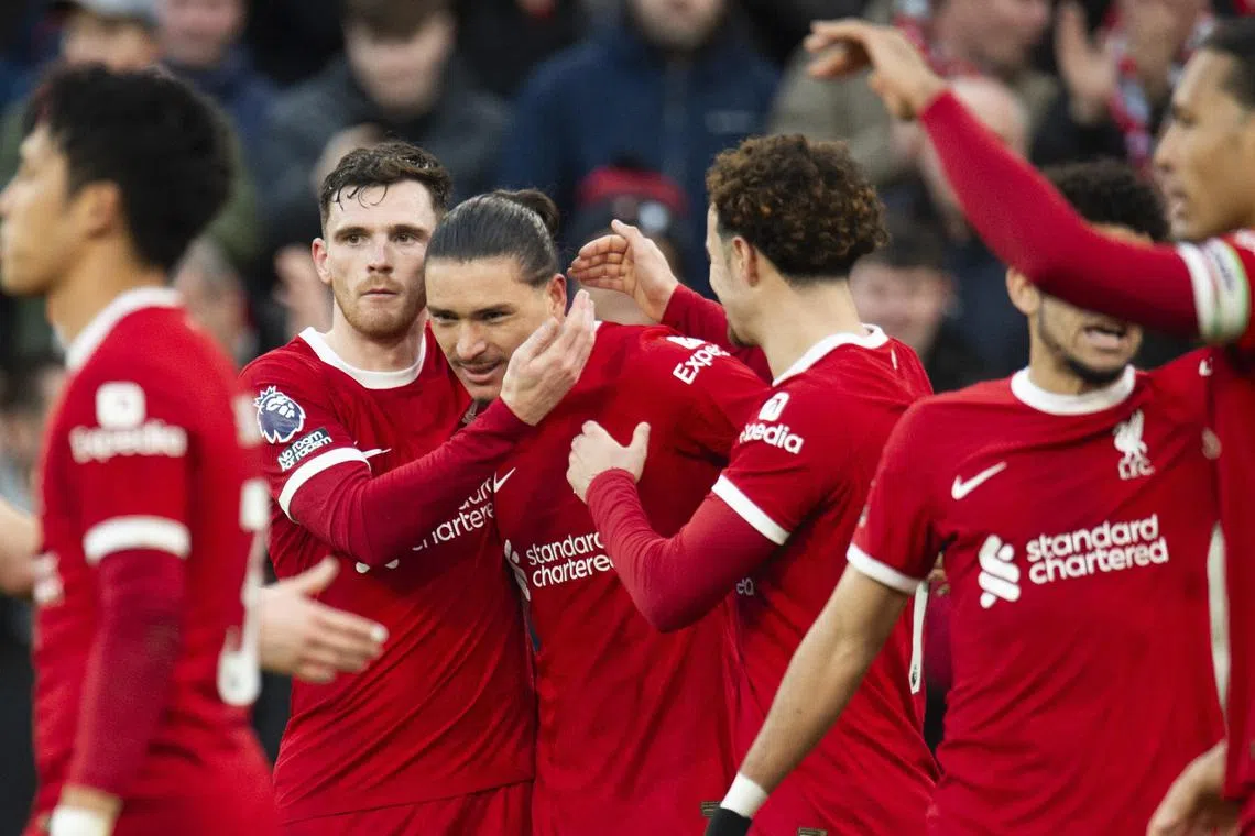Darwin Nunez celebrates with teammates after scoring Liverpool's third goal.