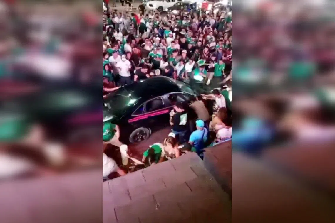 Videos posted on social media show a black car surrounded by people wearing football shirts of the Mexican national team. The car then accelerates into the crowd, throwing people into the air.