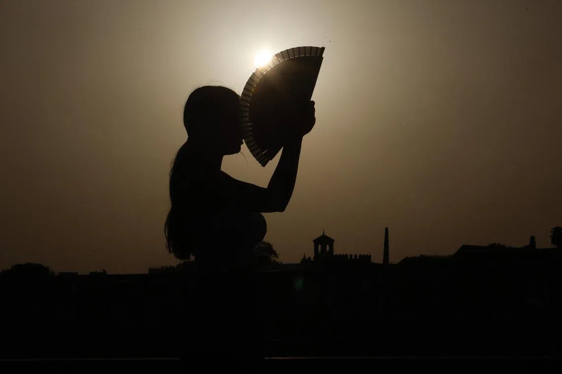 A woman fans herself in Cordoba, Spain, on Aug 17, 2025.