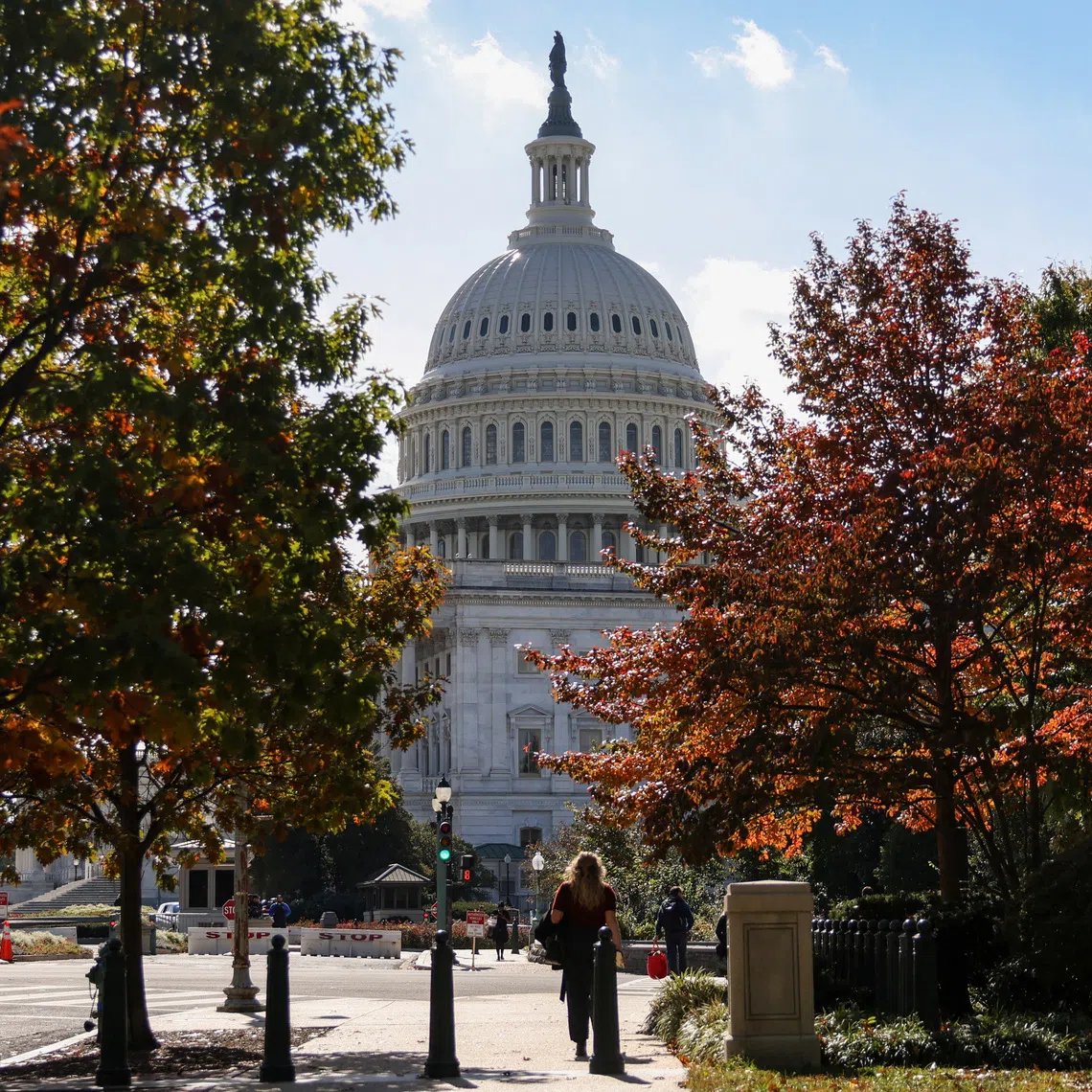 The U.S. Capitol building is framed between trees with fall foliage, weeks into the continuing U.S. government shutdown, in Washington, D.C., U.S., October 27, 2025. REUTERS/Kylie Cooper/File Photo