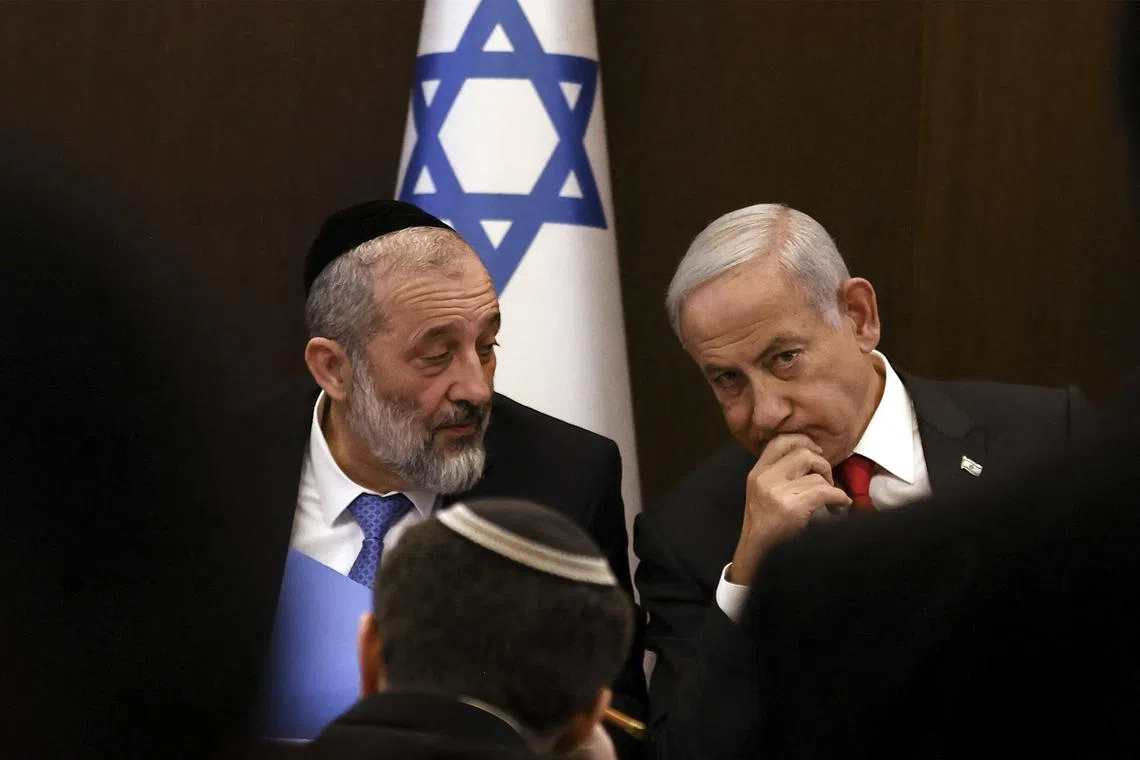 Israeli PM Benjamin Netanyahu (right) with Interior and Health Minister Aryeh Deri during a weekly cabinet meeting in Jerusalem, on Jan 8, 2023. 