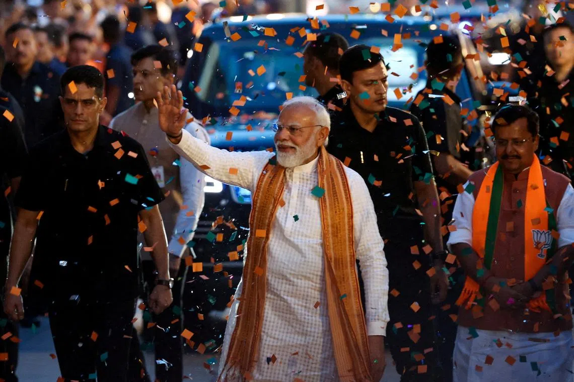 FILE PHOTO: India's Prime Minister Narendra Modi greets his supporters as he arrives at the Bharatiya Janata Party (BJP) headquarters as the BJP won the Assam state assembly election and was on course to win West Bengal, in New Delhi, India, May 4, 2026. REUTERS/Adnan Abidi/File Photo