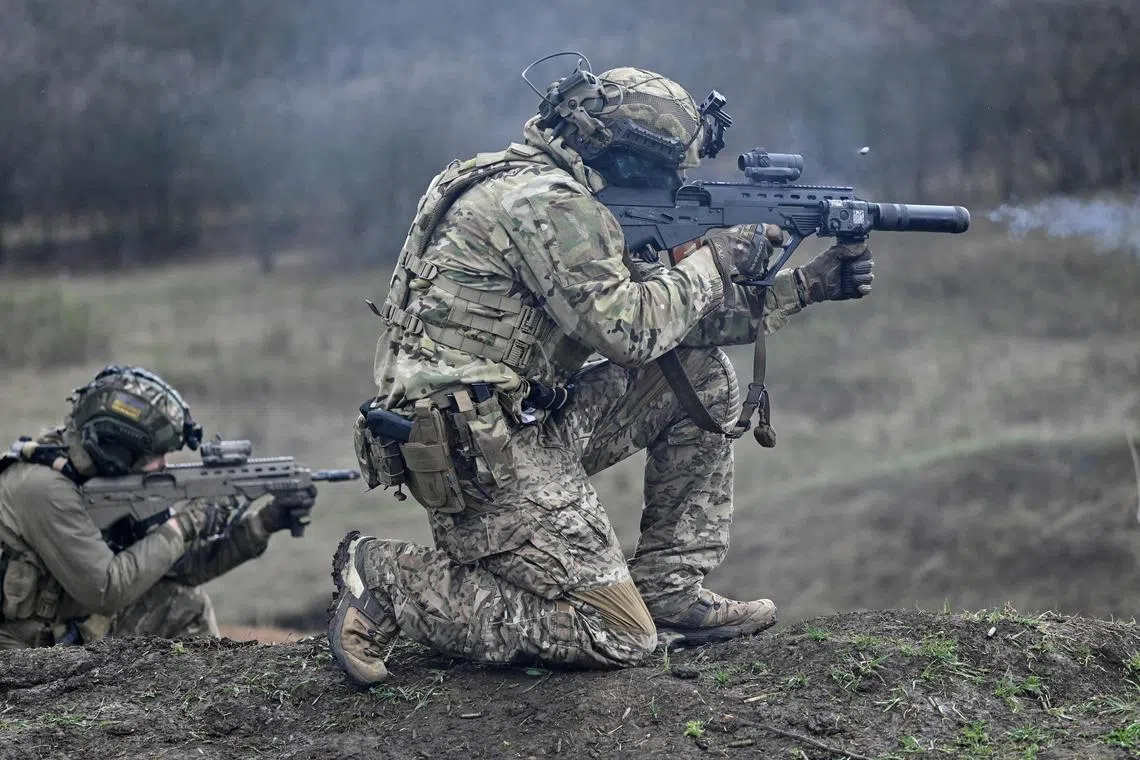 A Ukrainian Special Forces serviceman fires a Ukrainian made Malyuk assault rifle, during a training exercise in Ukraine's Donetsk region.
