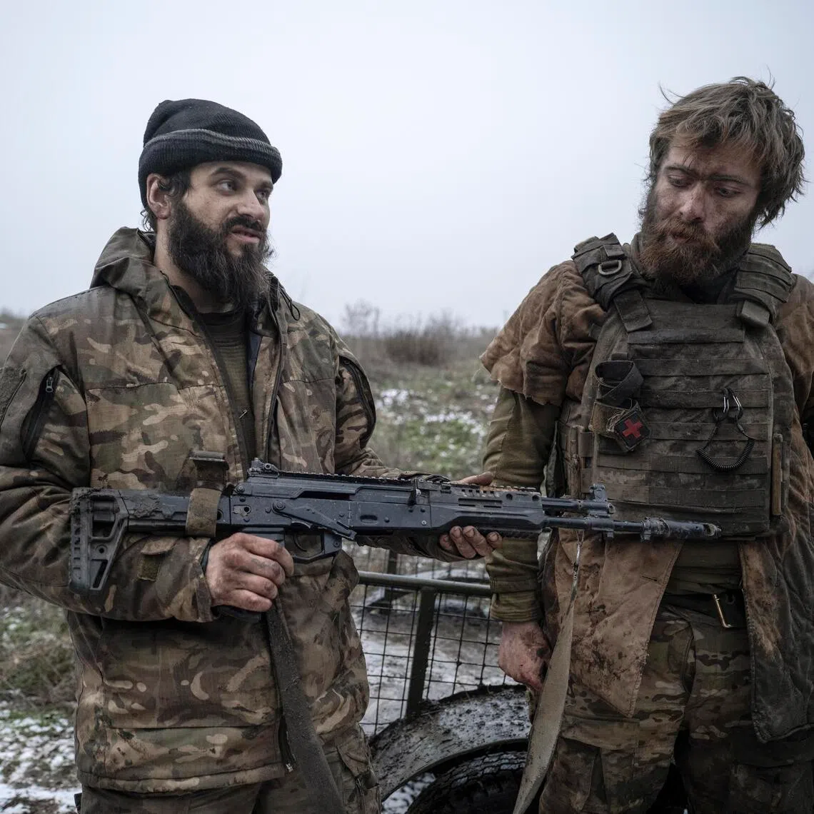 Ukrainian servicemen show off a trophy Russian weapon, after returning from front-line positions near Kostyantynivka, in Ukraine's Donetsk region.