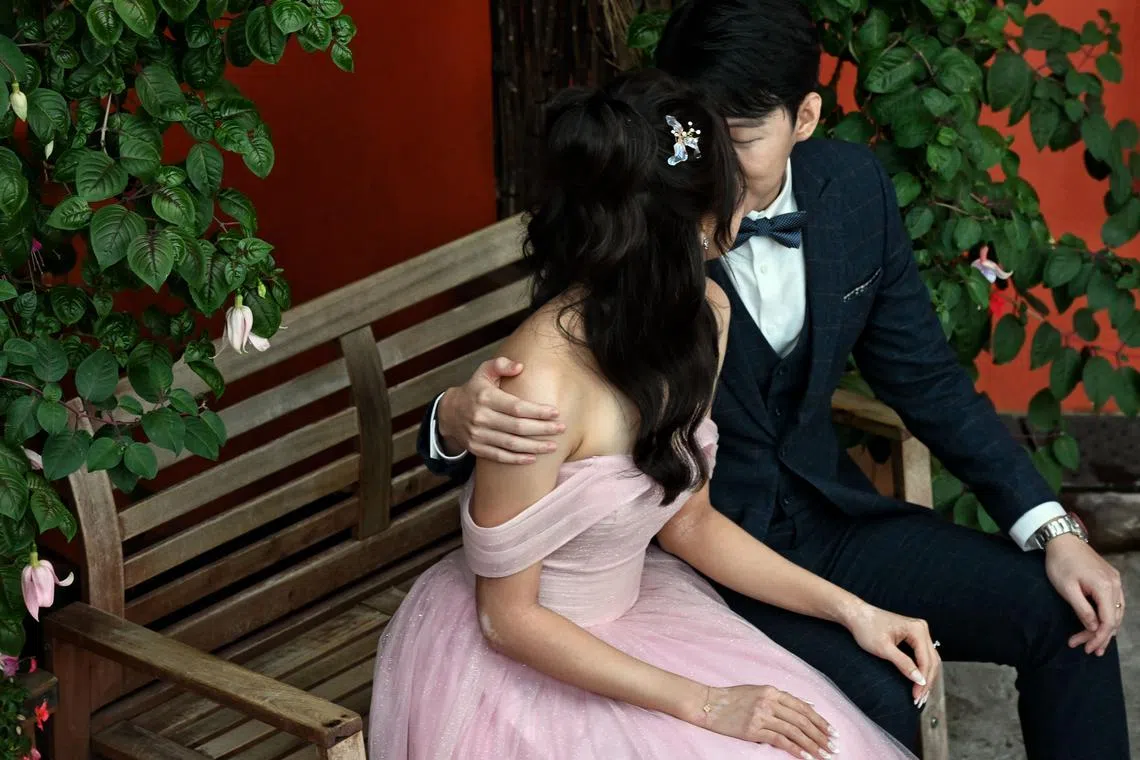 A couple during a wedding photograpy session at the Gardens by the Bay’s Sakura floral display on April 9.