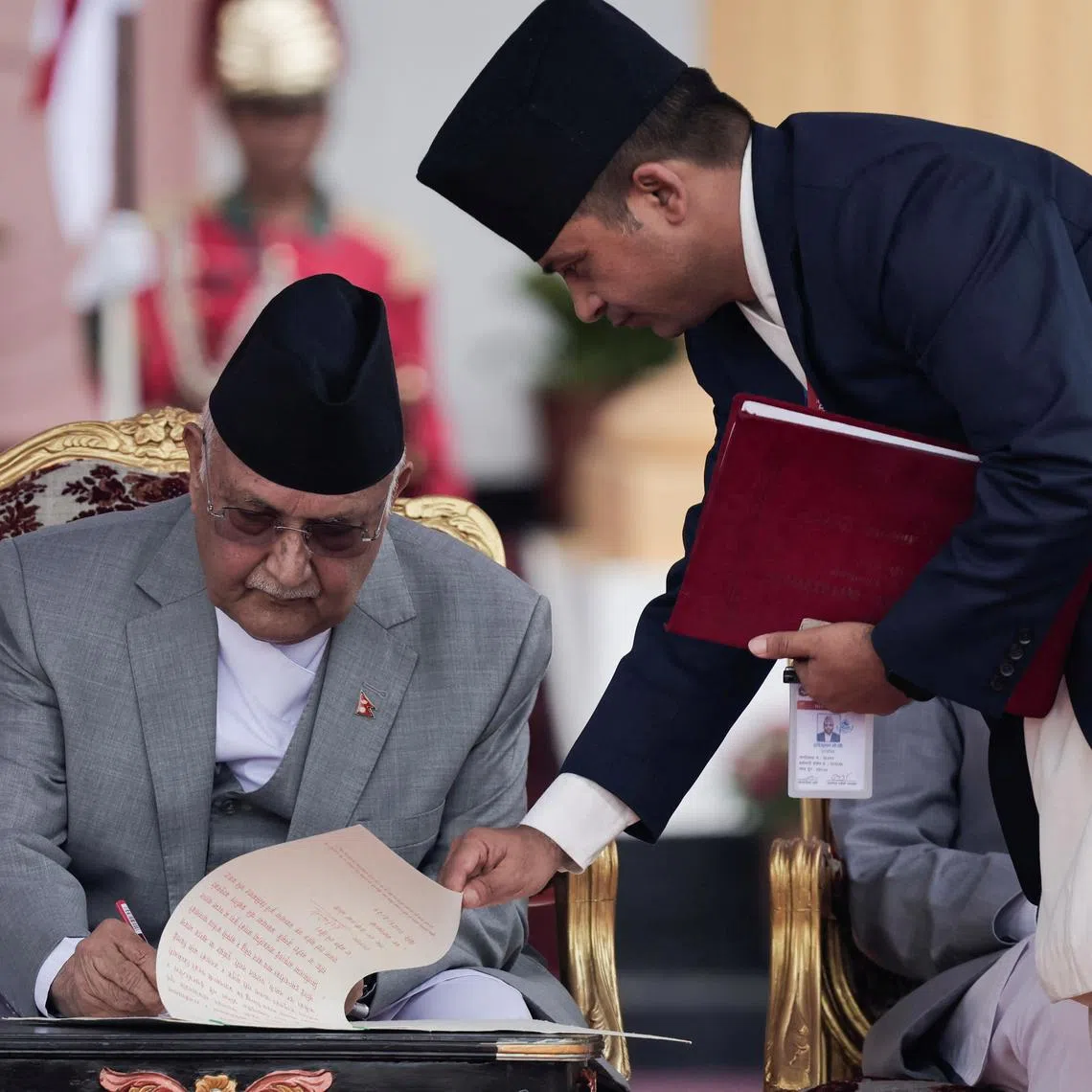 Newly appointed Prime Minister KP Sharma Oli signs a document after taking the oath of office at the presidential building "Shital Niwas" in Kathmandu on  July 15.
