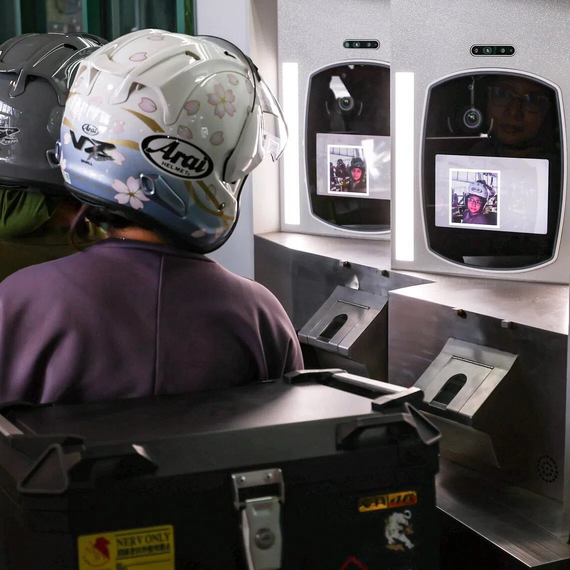 A demonstration of facial recognition clearance for motorcyclists and pillion riders at Woodlands Checkpoint on March 26, 2026. From March 31, facial images will progressively replace fingerprints as the primary biometric identifier for motorcycle travellers at land checkpoints, as part of the Immigration & Checkpoints Authority?s (ICA) New Clearance Concept aimed at enabling faster, contactless and more secure immigration clearance.