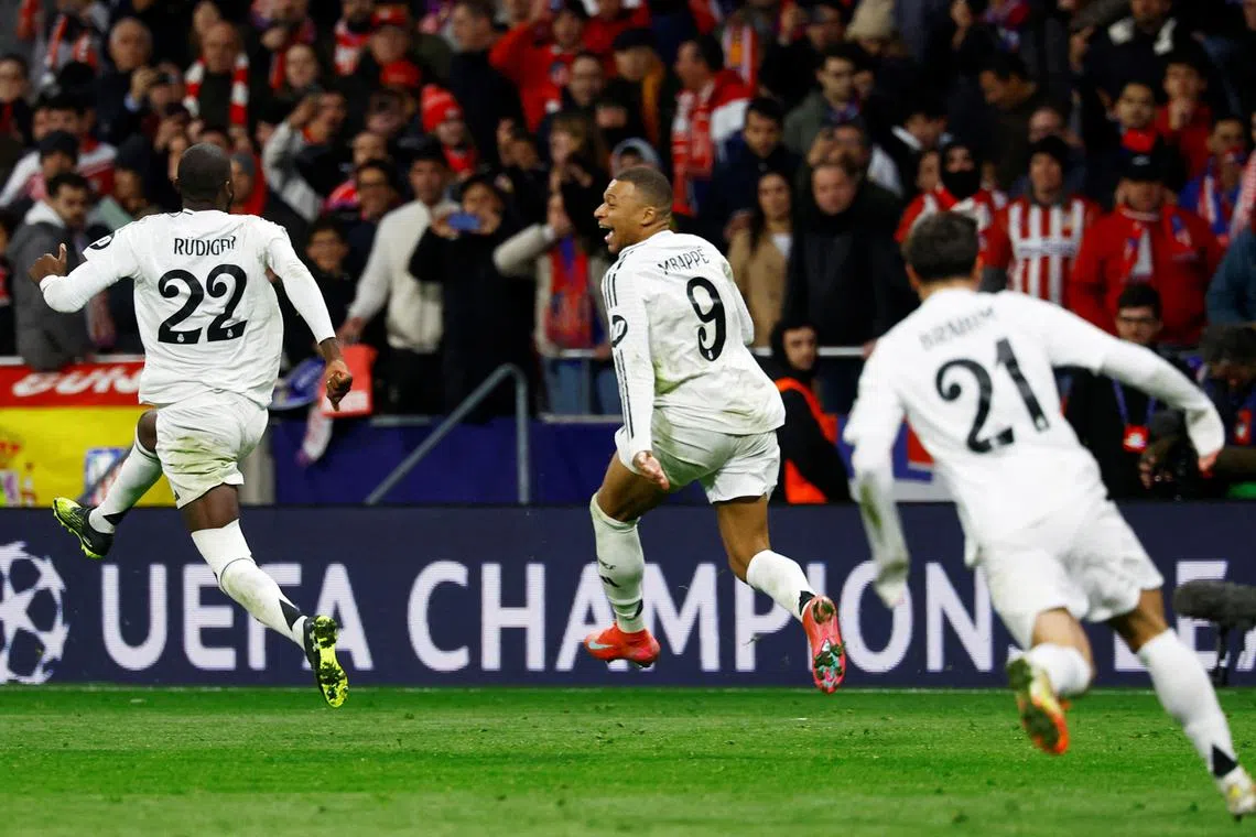 FILE PHOTO: Soccer Football - Champions League - Round of 16 - Second Leg - Atletico Madrid v Real Madrid - Metropolitano, Madrid, Spain - March 12, 2025 Real Madrid's Kylian Mbappe and Antonio Rudiger celebrate after the match REUTERS/Susana Vera/File Photo