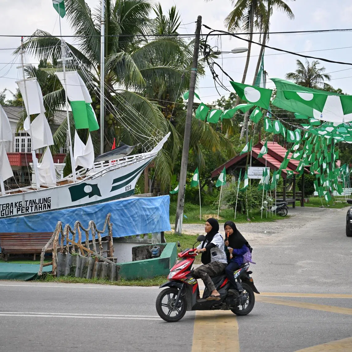 PAS flags and a ship made by supporters of the party are seen in Kedai Buluh, Kuala Terengganu, ahead of the state elections.