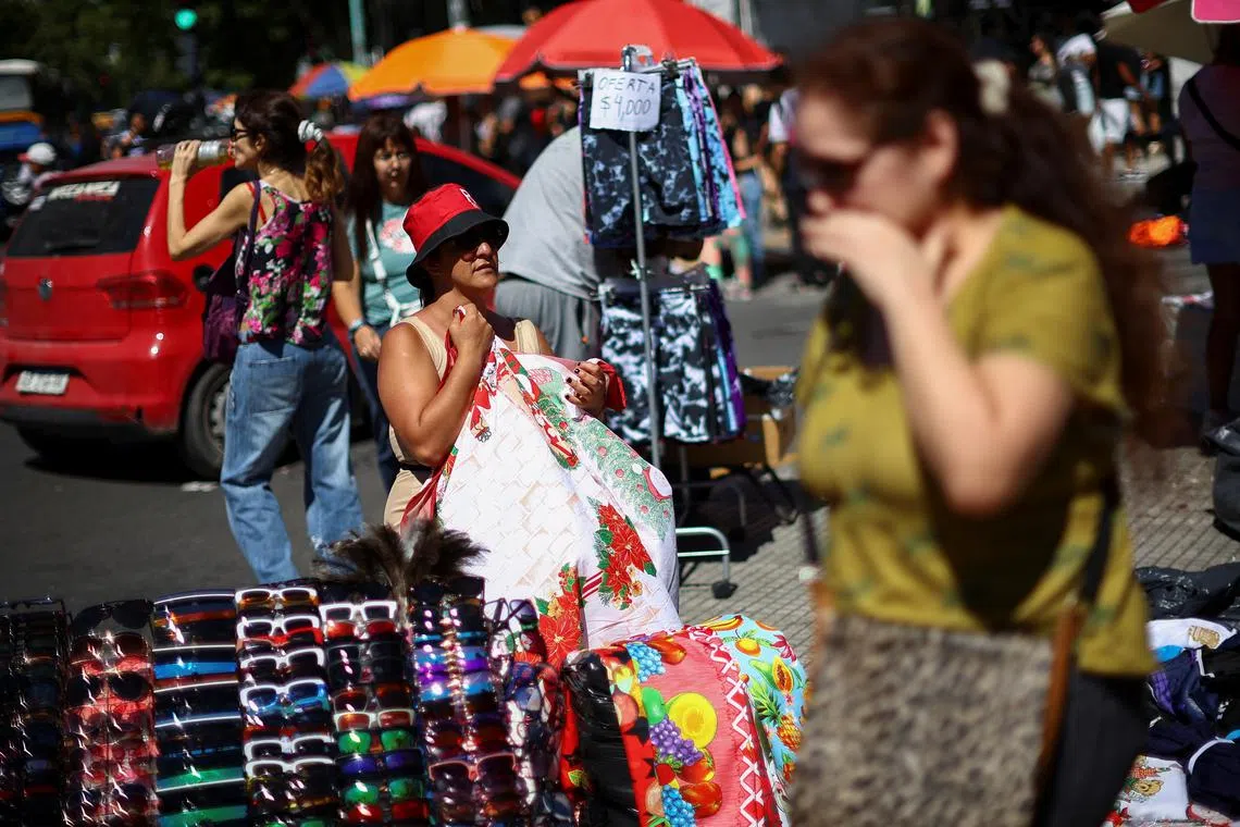 FILE PHOTO: A seller waits for costumers at a street market in Buenos Aires, Argentina December 23, 2024. REUTERS/Agustin Marcarian/File Photo