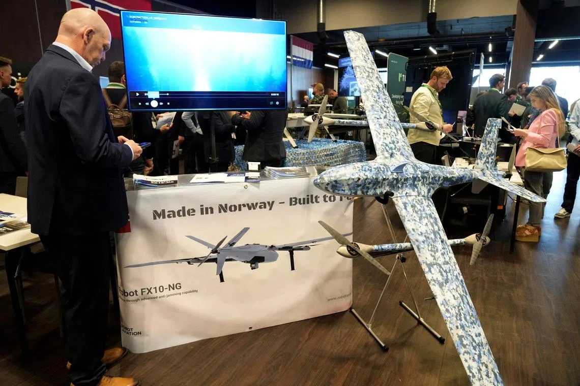 A man stands next to Robot Aviation's FX10NG drone displayed during the international Drone Summit in Riga, Latvia May 27, 2026. REUTERS/Ints Kalnins