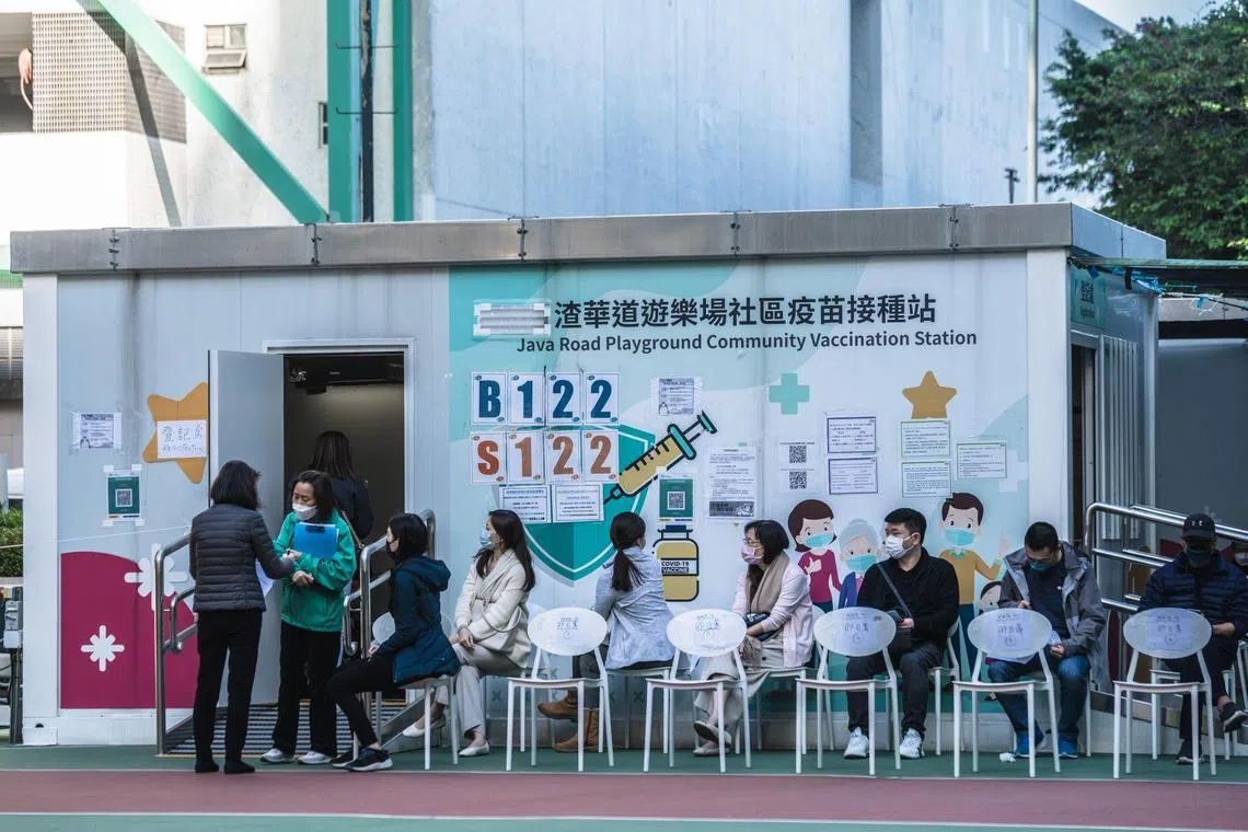 Residents queue at a Covid vaccination center in Hong Kong, China, on Thursday, Dec. 22, 2022. Hong Kong allowed people to enter bars without a negative rapid test, and scrapped limits on patrons for a raft of venues, as the financial hub continues to slowly loosen some of its last remaining Covid curbs. Photographer: Lam Yik/Bloomberg
