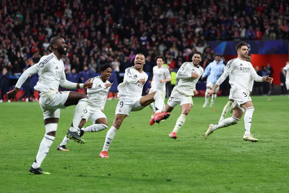 Real Madrid's Antonio Ruediger (left), Kylian Mbappe (third from left) and teammates celebrating their victory against Atletico on March 12.