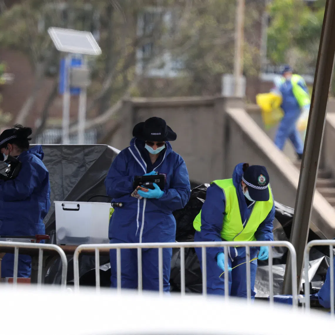 Members of the forensic team work at the scene of a shooting during a Jewish holiday celebration at Bondi Beach, in Sydney, Australia, December 15, 2025. REUTERS/Hollie Adams
