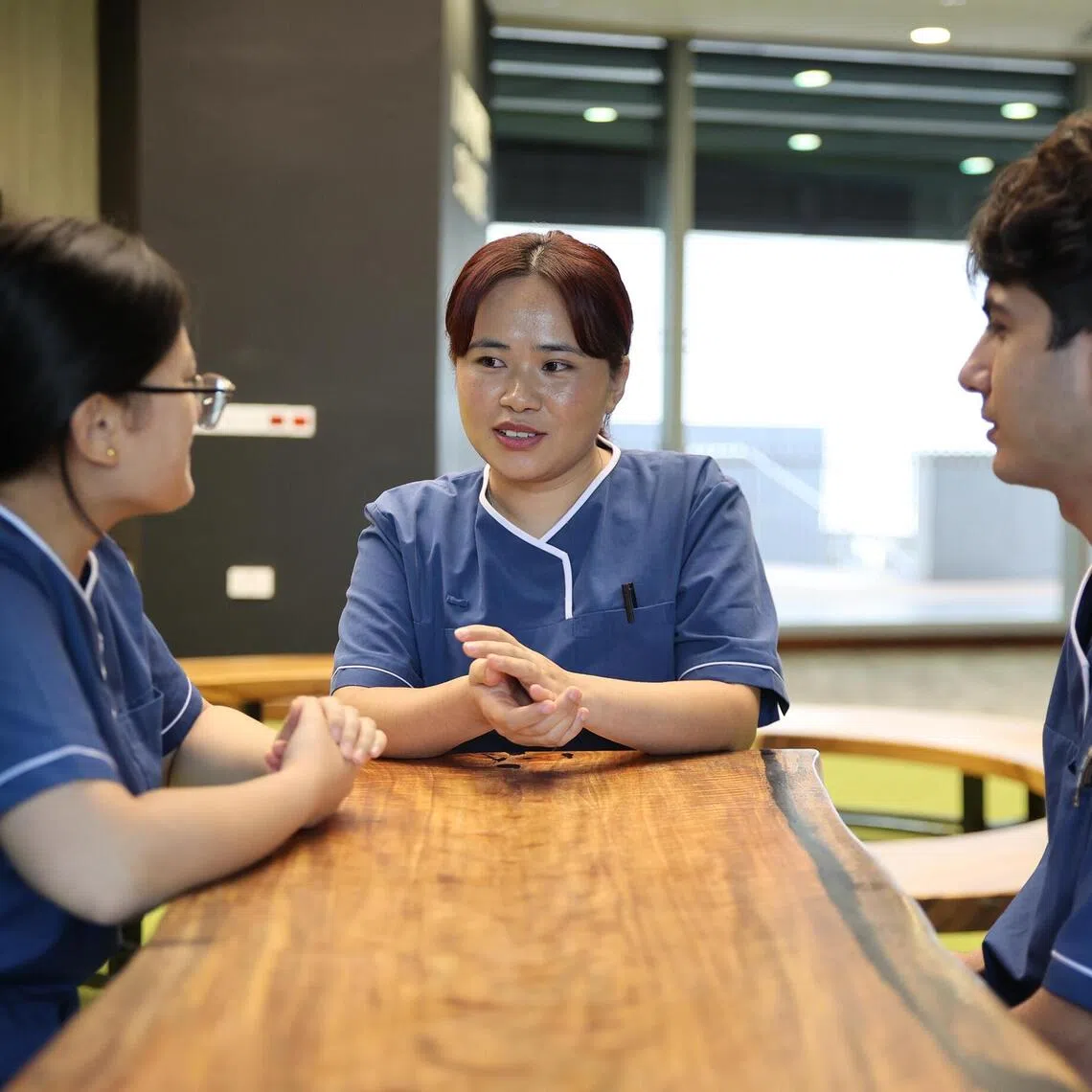 National Centre for Infectious Diseases staff nurse Darmita Rai (centre) is from Bhutan, a new source of foreign nurses here. She is pictured here talking to her fellow citizens Mr Pushpa Lal Adhikari and Ms Chimi Wangmo, who are both staff nurses at Tan Tock Seng Hospital (TTSH). They are among the six nurses from Bhutan working at these institutions