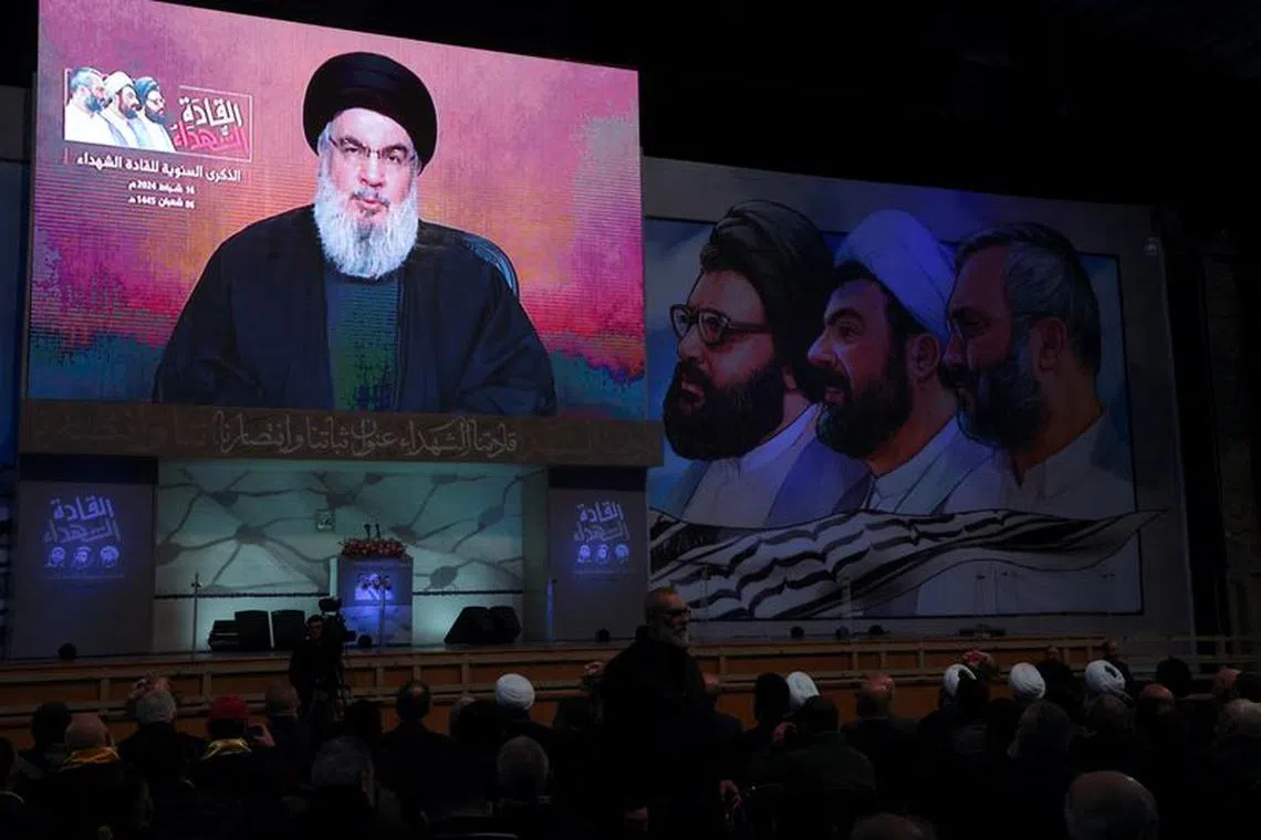 Lebanon's Hezbollah leader Sayyed Hassan Nasrallah appears on a screen as he gives a televised address during a rally commemorating the group's late leaders in Beirut's southern suburbs, Lebanon February 16, 2024. REUTERS/Mohamed Azakir
