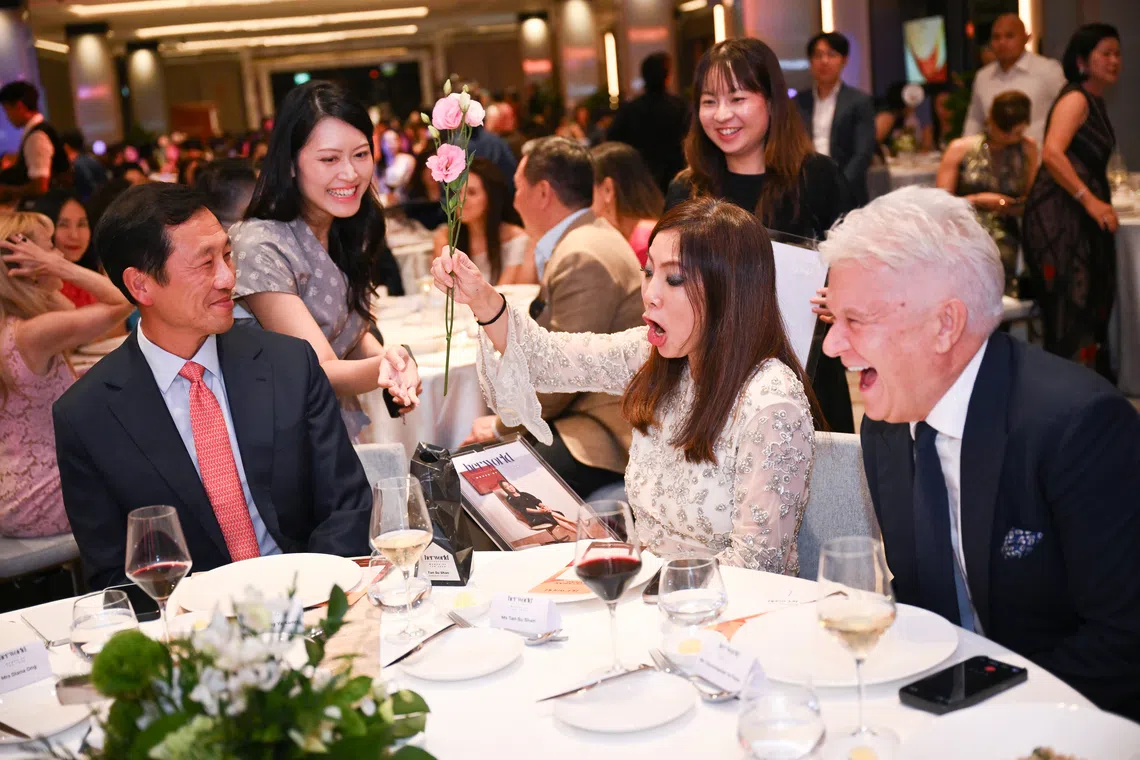 DBS group chief executive Tan Su Shan (centre) and her husband, Christopher Wilson (right), with Health Minister Ong Ye Kung during the annual Her World Women of the Year 2026 Awards on Oct 6.