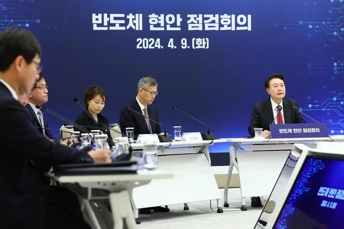 South Korean President Yoon Suk Yeol (R) speaks during a meeting with chip industry executives on April 9, 2024.