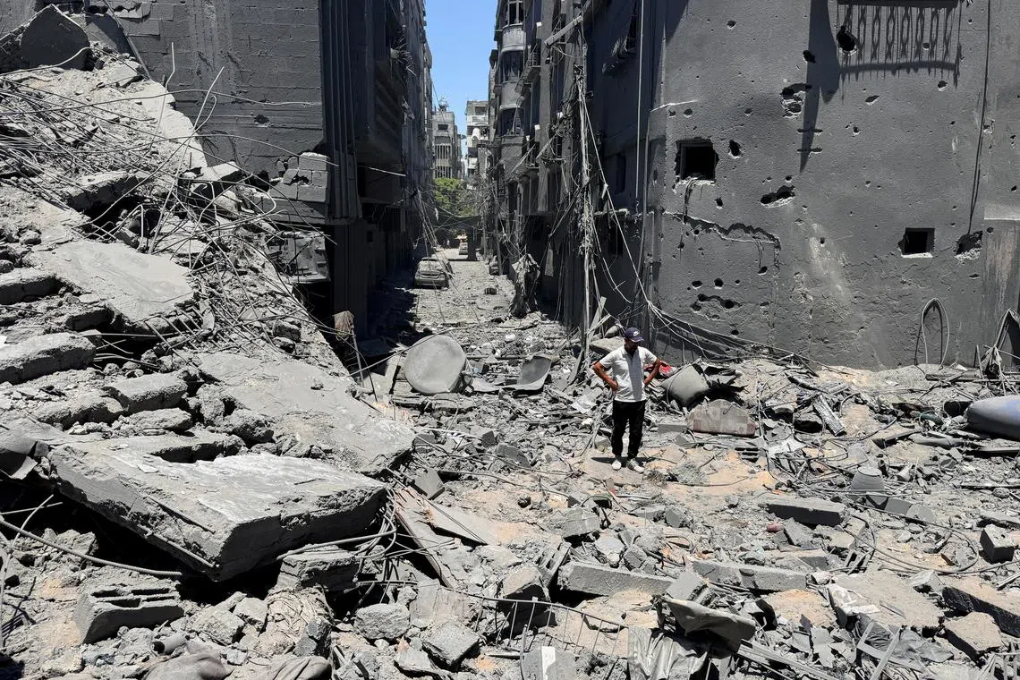 A Palestinian stands at the site of Israeli strikes on houses, amid Israel-Hamas conflict, in Gaza City, June 22, 2024. REUTERS/Ayman Al Hassi