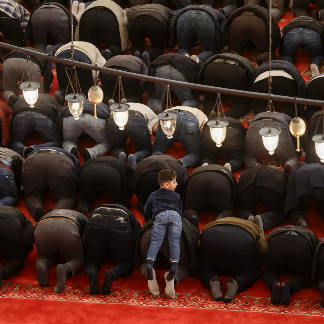 Turkish Muslims perform the first Friday prayers during Ramadan at the Suleymaniye Mosque in Istanbul, Turkey, on Feb 20.