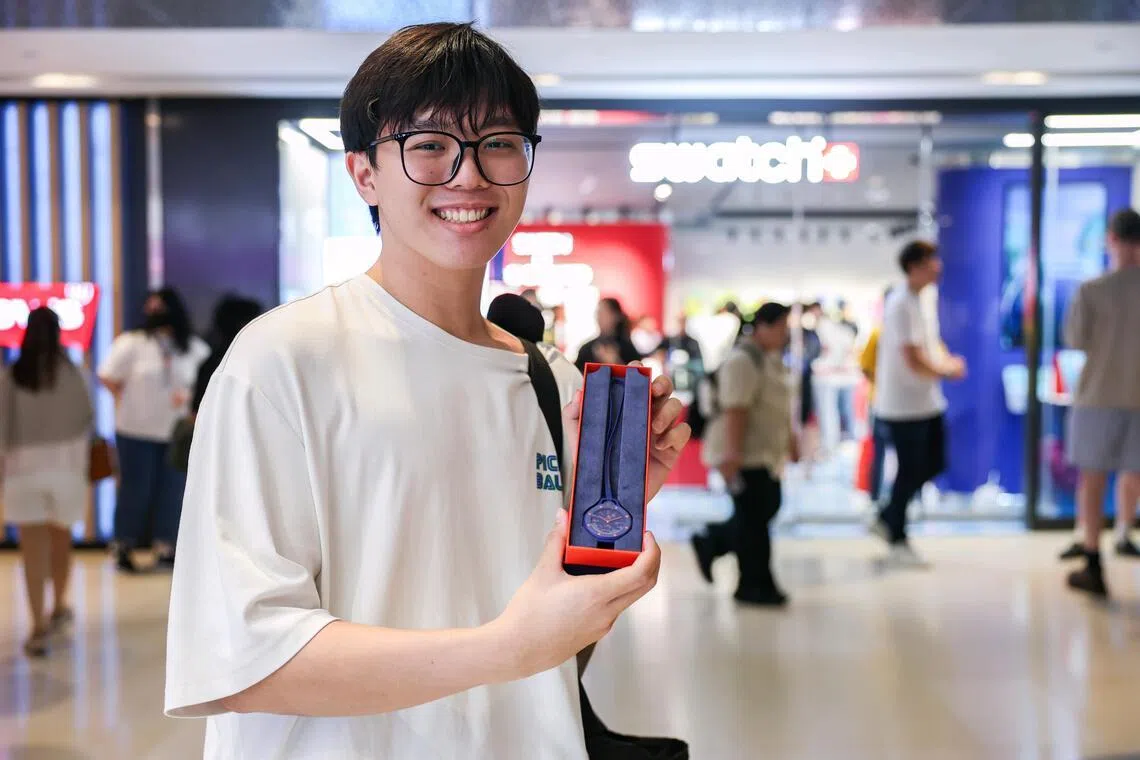 Mr Lim Jun Yu, 20, a graduate of Republic Polytechnic, posing with his Royal Pop watch, a collaboration between Swatch and Audemars Piguet, outside the Swatch outlet at ION Orchard during its launch on May 16, 2026.