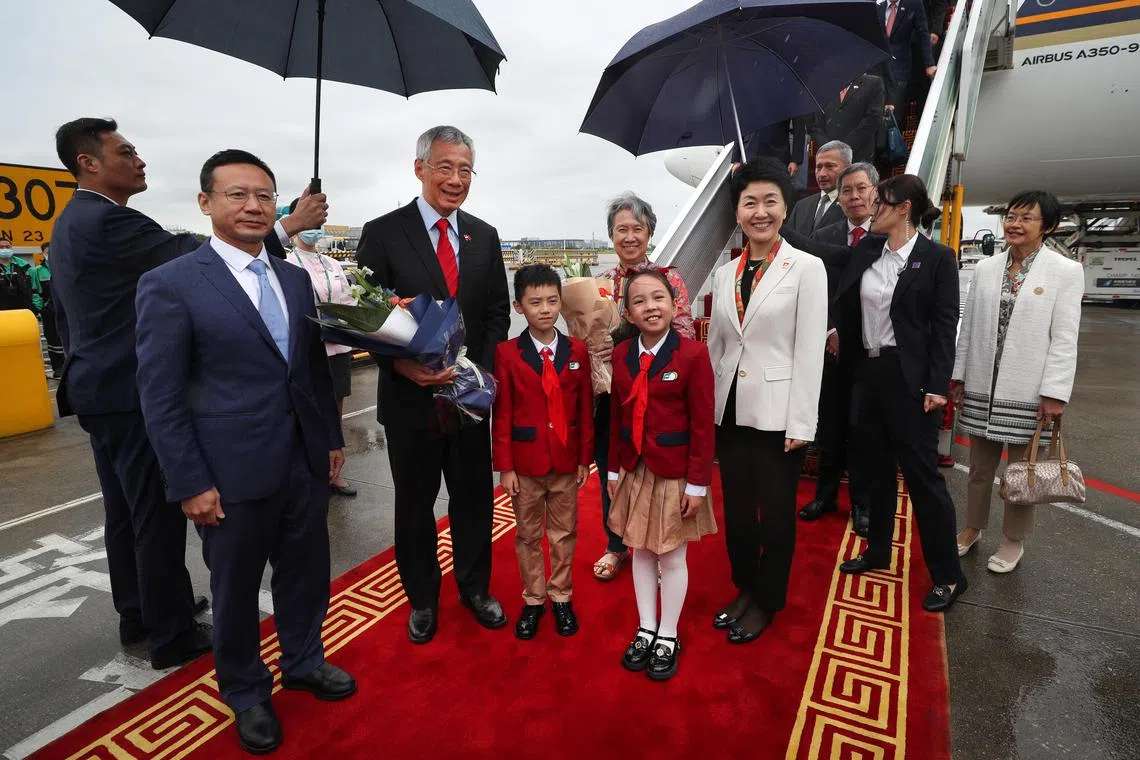 Prime Minister Lee Hsien Loong (third from left), accompanied by Mrs Lee (centre, behind), was greeted on the tarmac at Guangzhou Baiyun International Airport at around noon on Monday.