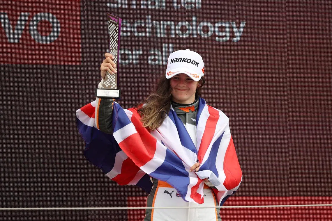 Formula One F1 - British Grand Prix - Silverstone Circuit, Silverstone, Britain - July 2, 2022 Racing X's Abbi Pulling celebrates with a trophy after finishing third in the W Series race REUTERS/Molly Darlington