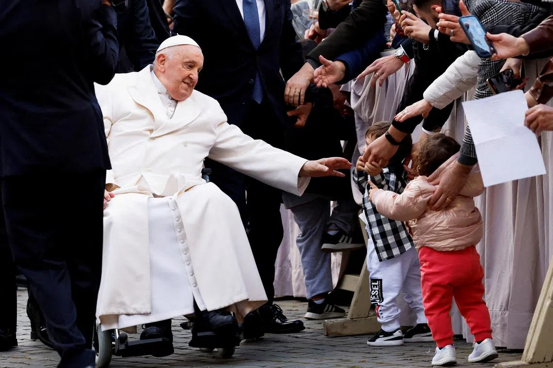 Pope Francis sits in a wheelchair as he greets the faithful on the day of the weekly general audience, in Saint Peter's Square at the Vatican, March 6, 2024. REUTERS/Remo Casilli/File Photo