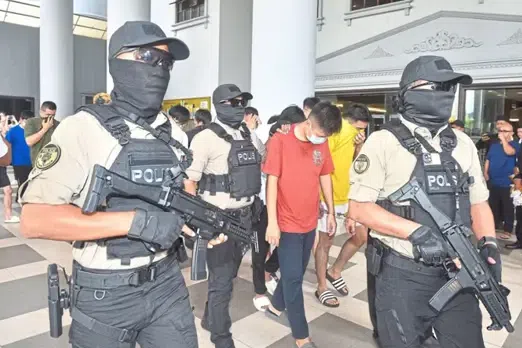 Police escort to court some of the men involved in the attack.
